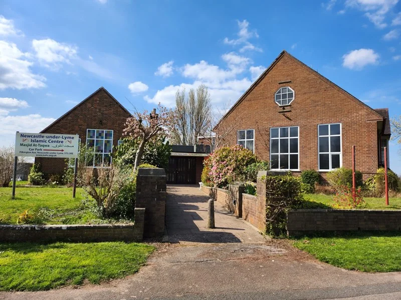 Masjid At-Taqwa: a red-brick former church hall with an octagonal gable window and a small spire